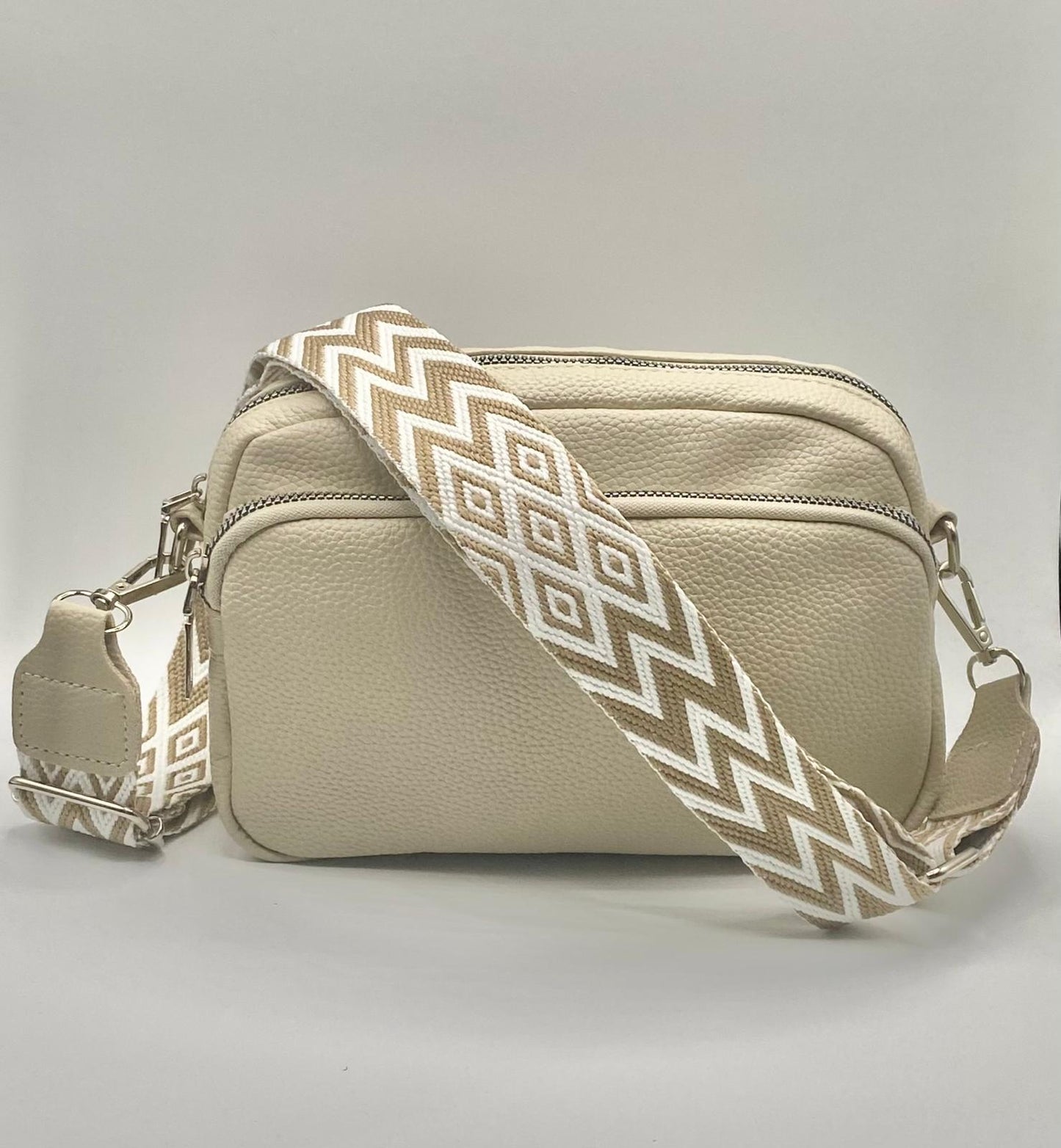 Small PU leather bag with trendy wide pattern strap.