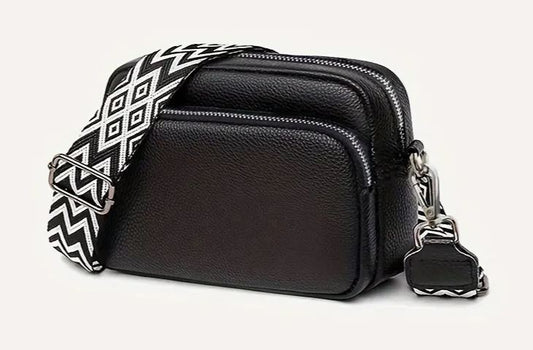 Small PU leather bag with trendy wide pattern strap.