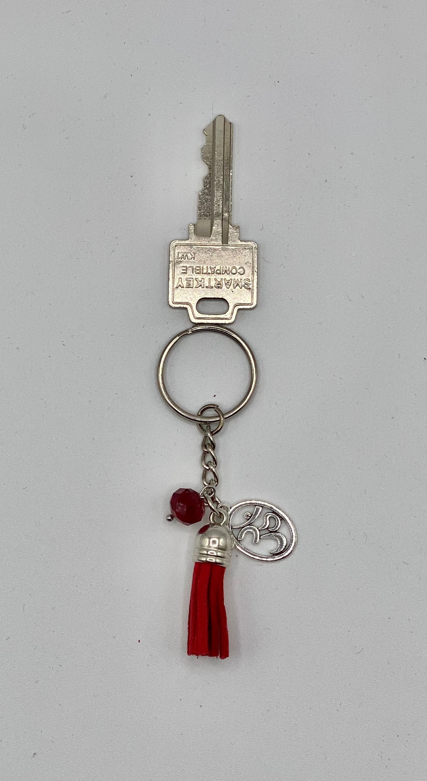 Key holder with burgundy tassels and OM charm and burgundy bead