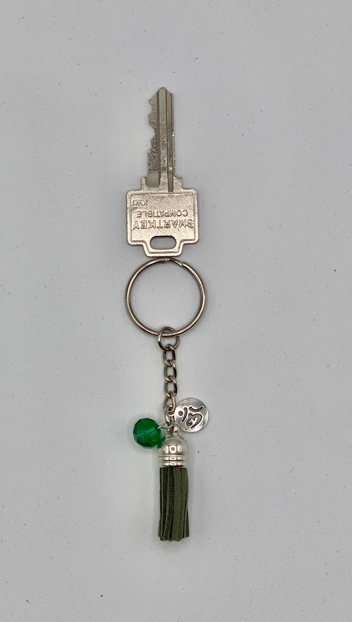 Key holder with green tassels and OM charm and green bead