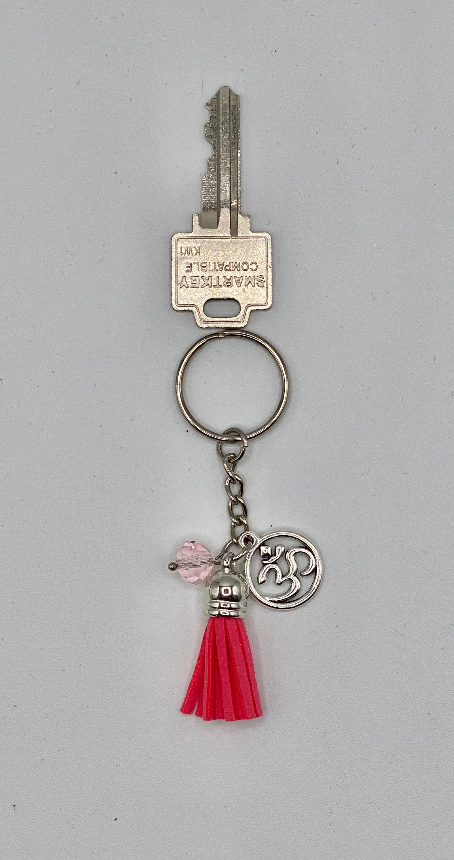 Key holder with pink tassels and OM charm and pink bead