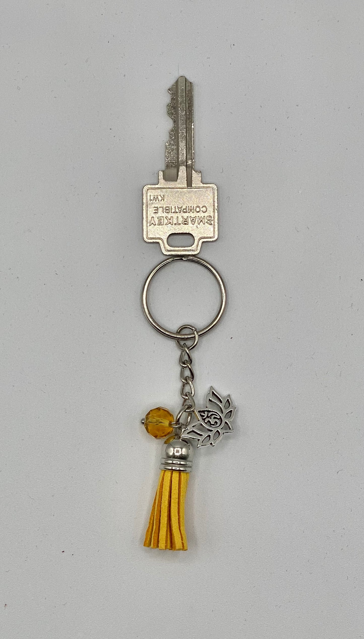 Key holder with yellow tassels and Lotus Flower OM charm and yellow bead