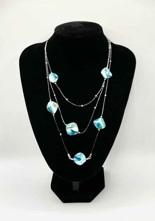 Three layers nylon necklace with blue shells.