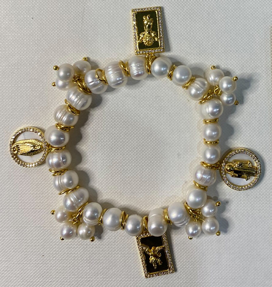 Gold plated bracelet with charms and freshwater pearls.