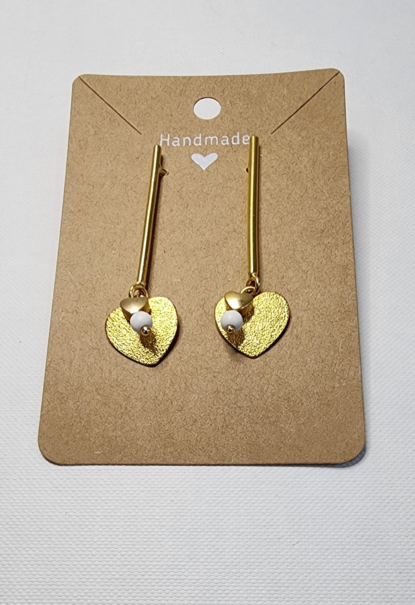 Gold plated heart earrings with white turquoise bead.