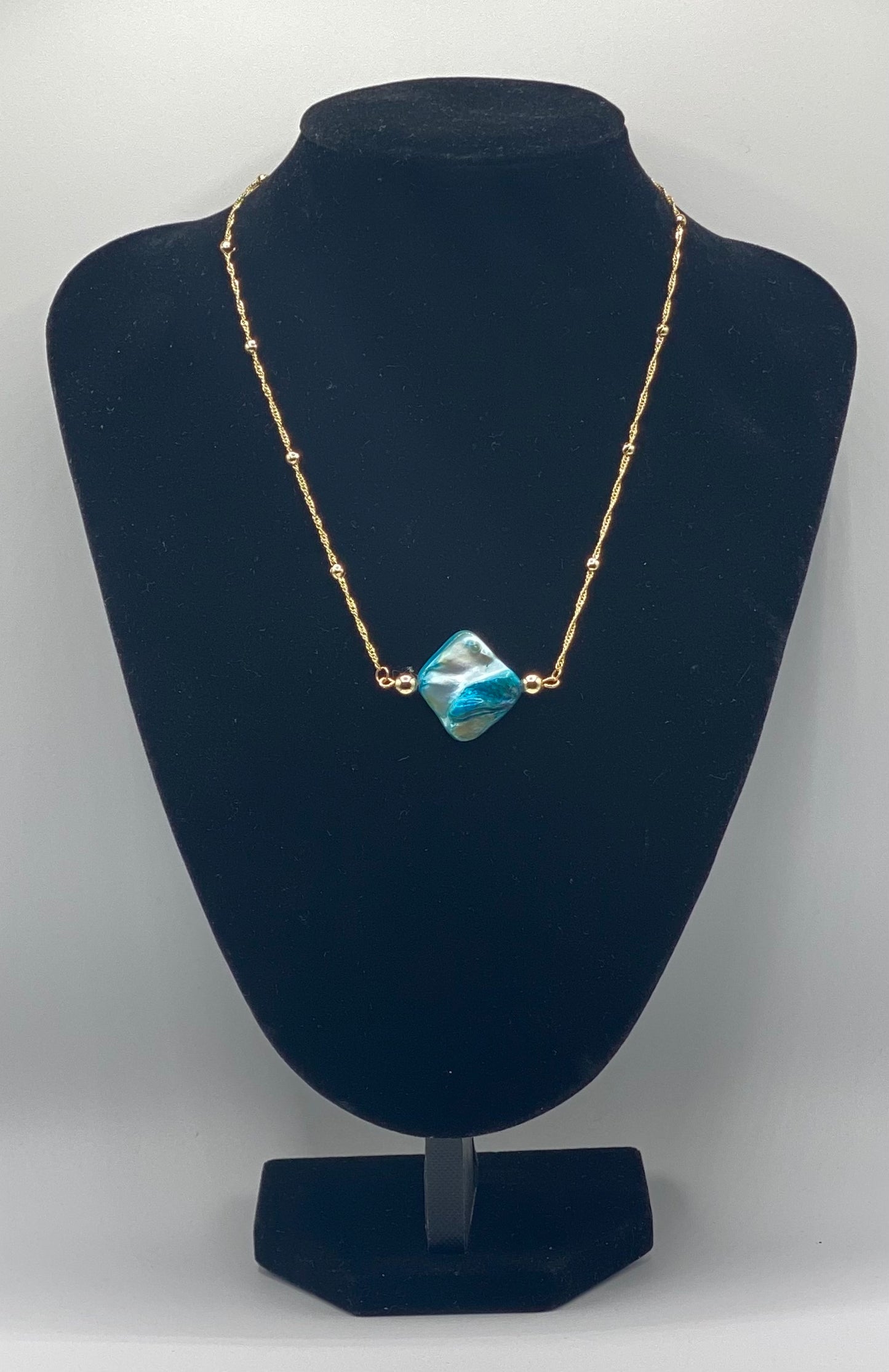 Gold plated necklace with blue shell charm